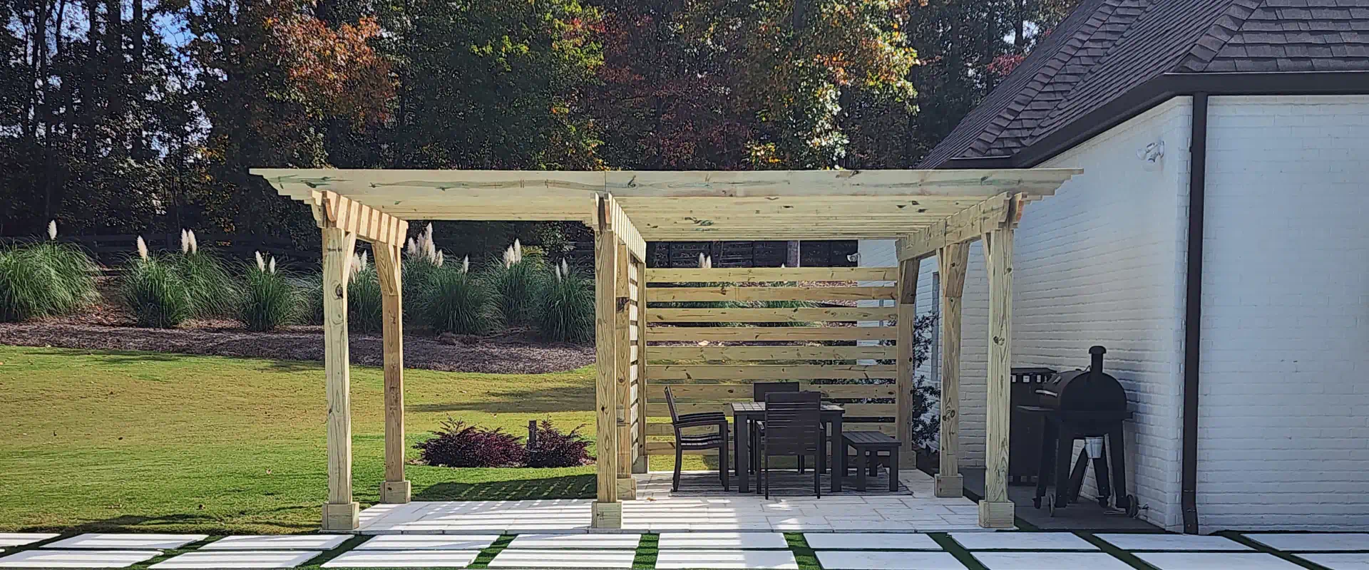 wooden pergola on a side of swimming pool and grilling space